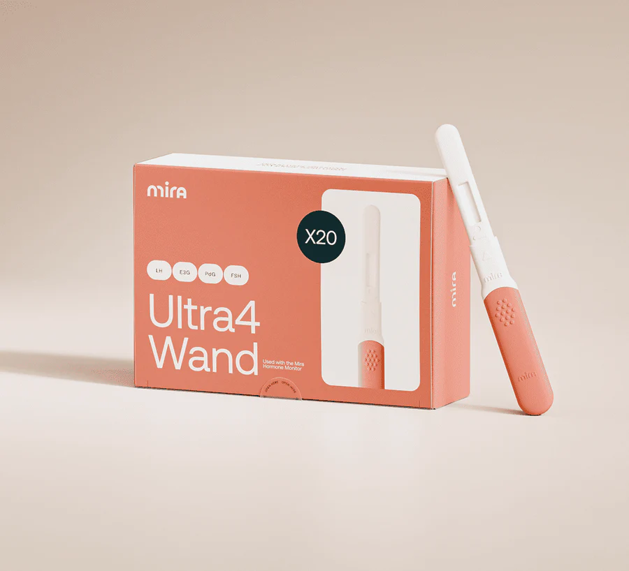 A Mira Ultra4 Kit box with a single Mira Hormone Monitor testing wand placed next to it on a light, neutral background. , Kiara Health Fertility