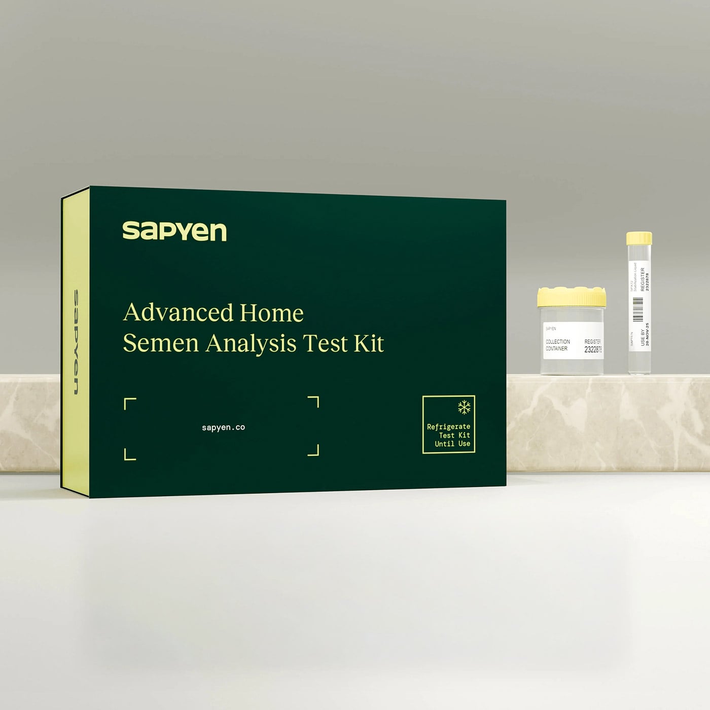 A green box labeled “Advanced Home Semen Analysis Test Kit” from Sapyen sits on a countertop next to a specimen vial with a yellow cap, offering convenient at-home sperm DNA test solutions.