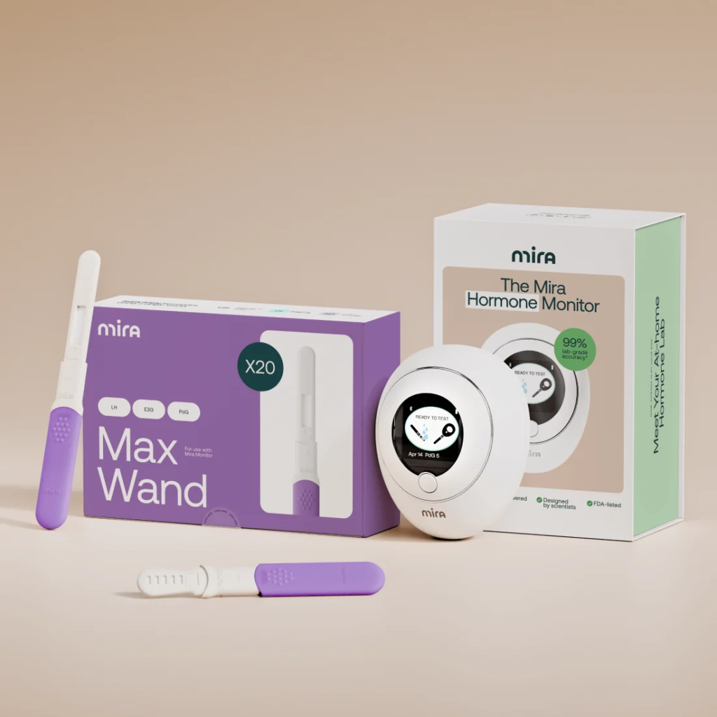 A Mira hormone monitor device shown with its packaging, two test wands, and a box of 20 Max Wands for the fertility tracker. , Kiara Health Fertility