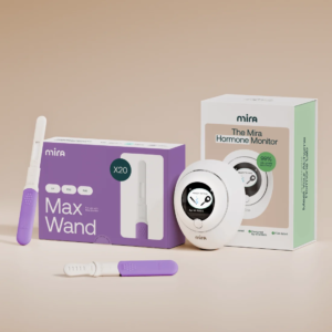 A Mira hormone monitor device shown with its packaging, two test wands, and a box of 20 Max Wands for the fertility tracker. , Kiara Health Fertility